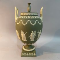 A mid-20th century Wedgwood green jasper two-handled vase and cover, the ovoid body sprigged with
