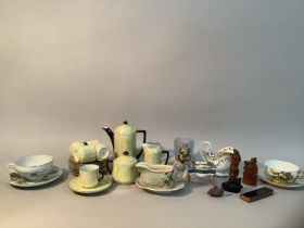 A yellow lustre coffee set with black handles, two eggshell tea cups and saucers, moulded