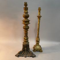 A gilt metal baluster table lamp, on an inverted leaf base with flower head rounders, 54cm high to