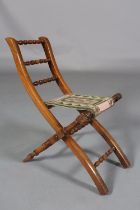 A VICTORIAN CHILD'S ROSEWOOD FOLDING CHAIR WITH TRIPLE SPINDLE BAR BACK, slung needlework seat, on