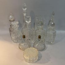 Cut glass water jug, pair of spirit decanters and five further decanters, powder bowl and cover