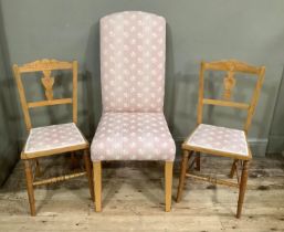 A modern single chair upholstered in pink and ivory woven fabric, on beech legs together with a pair