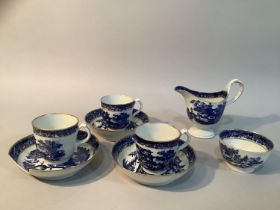 An early 19th century coffee set in blue and white pattern with gilt comprising three cups, three