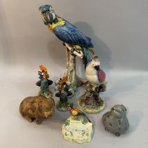 A large Continental pottery figure of a parrot, a pair of Italian pottery cockerels, a Staffordshire