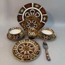 A pair of Royal Crown Derby trios, cup, saucer and plate, pattern 1128, date code c1930/31, together