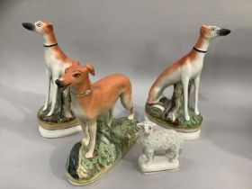 A pair of 19th century Staffordshire greyhounds in seated positions 20.5cm high together with a