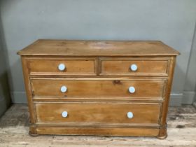 A stained pine chest of two short above two long drawers on plinth base, 117cm