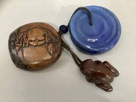 A Chinese fruitwood box, the base and cover both carved in low relief with the head of a Pekinese,