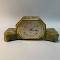 An Elliot onyx cased mantle clock of stepped form and octagonal silver dial with Roman numerals,