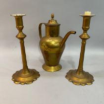 A pair of 18th century brass candlesticks on circular dimed base with petallated rim 26.5cm high,