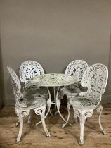 A set of cast iron white garden chairs and table, ornate with pierced decoration