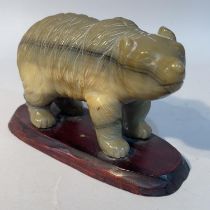 A Chinese carved agate figure of a bear, on hardwood stand, 9.5cm high overall