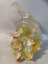 A set of five Lalique factice perfume bottles for Nina Ricci L'Air du Temps of graduated size, the