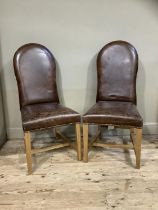 A pair of brown leather close nail upholstered chairs on square framing