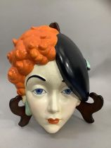 A Beswick Art Deco pottery face mask of a girl wearing a black beret, printed mark and painted No: