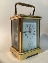 A modern brass carriage clock with eight day repeat alarm movement, 18cm high over handle
