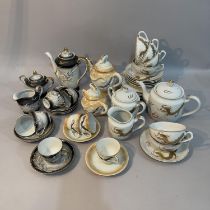 A charcoal eggshell tea service for six with teapot, milk jug etc. two further tea sets moulded
