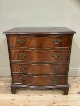 A mahogany reproduction serpentine fronted chest of four drawers on bracket feet, 70cm wide