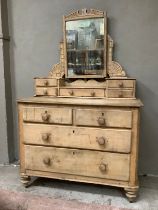 A pine dressing table and drawers having two short above three long drawers below a dressing