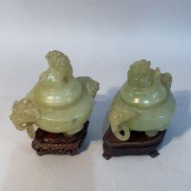 Two matched Chinese soapstone vases, each having a domed cover with dog of Fo finial and twin animal