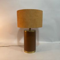A Luis collection of brass mounted and leather table lamp of drum shape with faux suede shade,