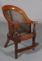 A VICTORIAN CHILD'S MAHOGANY AND BERGERE CANED TUB BACK CHAIR, on turned legs with foot rest and