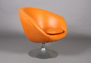 A 1960s orange PVC swivel tub chair on circular aluminium base