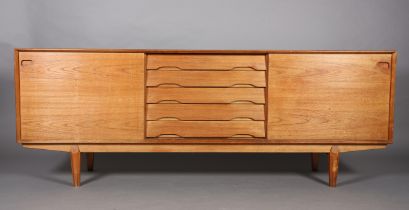 Drylund, Denmark c. early 1970s, a teak sideboard having five drawers to the centre flanked by a