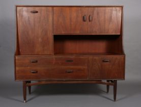 A G-Plan teak cabinet circa late 1960's, having a drop front, two door cupboard above an open