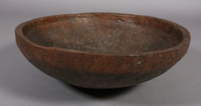 A large rough-hewn carved hardwood bowl, 23cm high x 66.5cm diameter