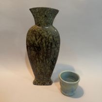 A studio pottery vase of slender form with flared neck having a dripped brown and green glaze marked