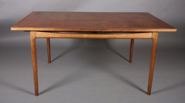A 1970's teak and walnut extending dining table, rectangular, on rounded and tapered legs, 89cm wide