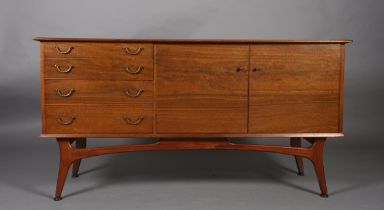 Alfred Cox, A walnut sideboard 1950s having four graduated drawers with gilt metal swing handles