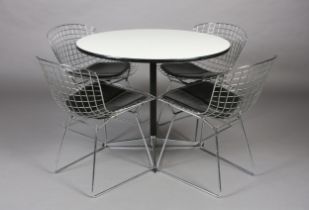 A set of four Bertoia style wire work chairs with black seat pads, after the original design for