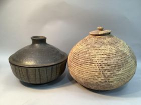 A stoneware pot and cover with dripped brown glaze together with an eastern woven basket with lid