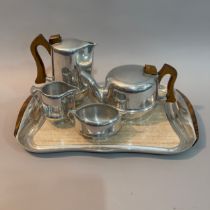 A Piquotware aluminium tea set comprising teapot, milk jug, sugar bowl, hot water pot and serving