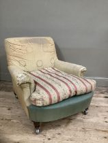 A Howard and Sons style armchair on turned legs with later shepherds castors