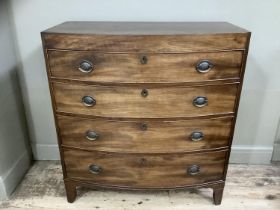 A Victorian mahogany bow fronted chest of four long drawers with brass escutcheons on bracket