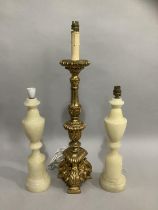 A gilt baroque style table lamp, 57cm high to fitting, together with a pair of alabaster table lamps