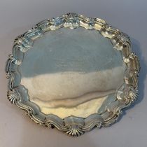 An Edward VII silver tray, London 1908 Thomas Bradbury & Sons Ltd of circular outline with scolloped