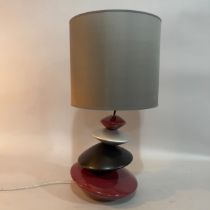 A ceramic pebble tower table lamp in burgundy, black and pewter, with pewter-coloured drum shade,