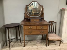 An Edward VII mahogany satinwood inlaid dressing table with shield shaped mirror with drawers on