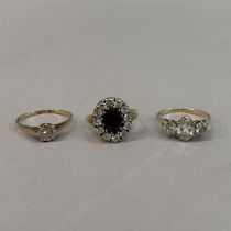 Three dress rings all in 9ct gold, variously set in cubic zirconia and sapphire, total approximate