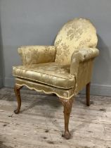 A Georgian style walnut armchair on cabriole legs upholstered in gold fabric