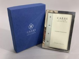 A modern sterling silver photography frame of plain design by Carrs of SHeffield, boxed, as new,
