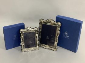 A pair of modern sterling silver photograph frames of graduated size, boxed, as new, 26.5cm x 19.5cm