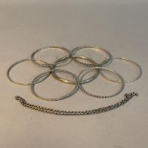 A collection of bangles, three George V silver and four in white metal (tests as silver), together