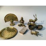 Indian brass figure of a holy man together with a brass dish worked with fish, a brass spherical
