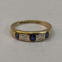 A Victorian Sapphire and diamond five stone ring in 18ct. gold, the graduated oval facetted