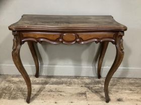 A mahogany continental fold over tea table with carved apron above carved cabriole legs